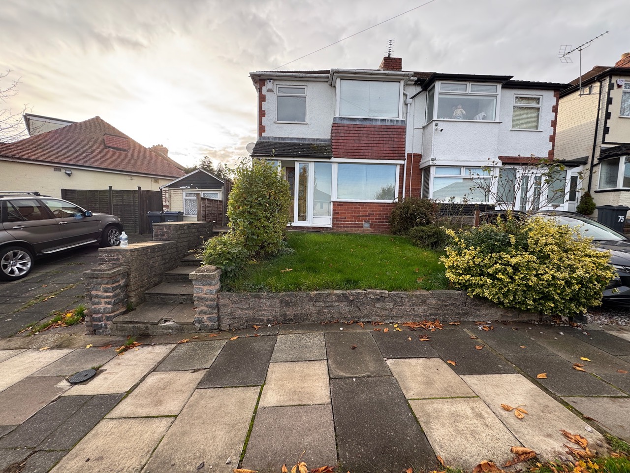 Before: raised front garden with lawn, shrubs and masonry steps
